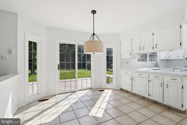 15 Horseshoe Dr, Mount Laurel, NJ 08054 - kitchen featuring light countertops, white cabinetry, light tile patterned floors, and pendant lighting