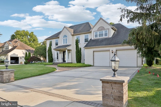 15 Horseshoe Dr, Mount Laurel, NJ 08054 - view of front of house featuring concrete driveway, a garage, stucco siding, a front yard, and roof with shingles