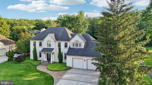 15 Horseshoe Dr, Mount Laurel, NJ 08054 - view of front of house with driveway, stucco siding, a front lawn, a chimney, and roof with shingles