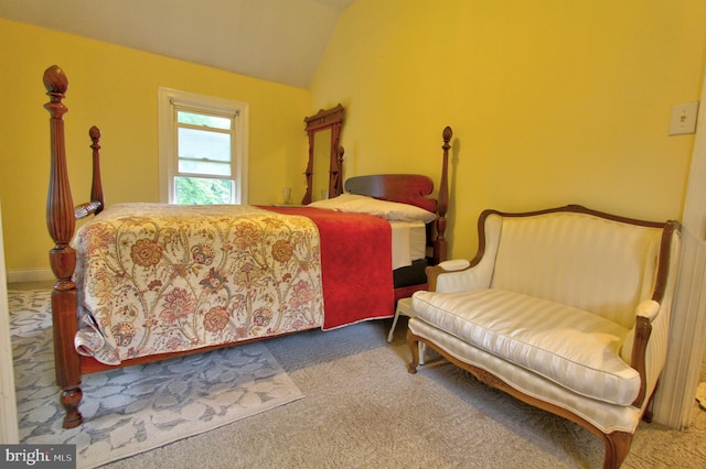 carpeted bedroom featuring lofted ceiling