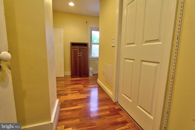 hallway with wood finished floors, recessed lighting, and baseboards