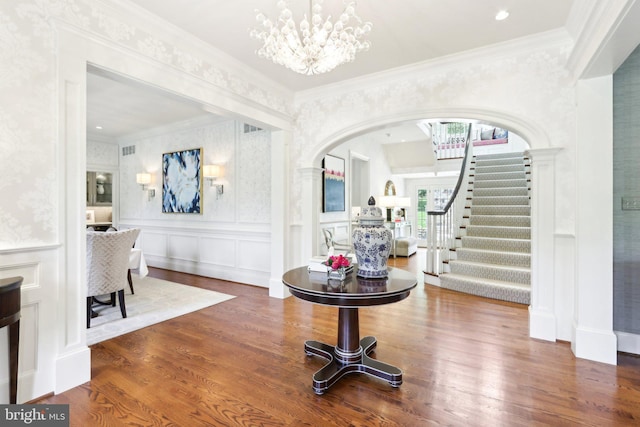 51 Farrier Ln, Newtown Square, PA 19073 - entryway with stairs, wood finished floors, a chandelier, arched walkways, and ornamental molding