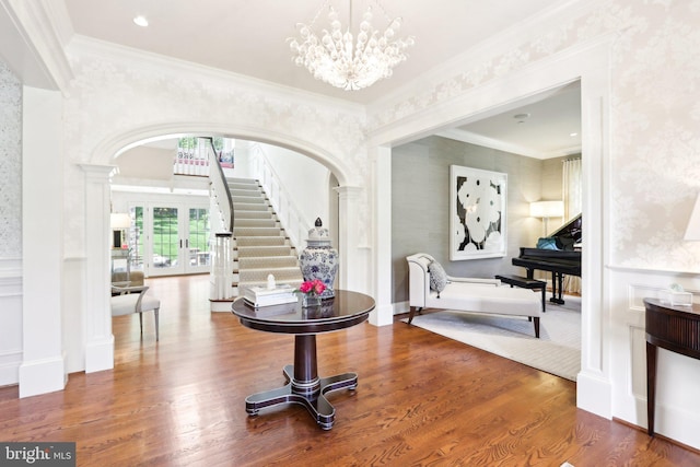 51 Farrier Ln, Newtown Square, PA 19073 - foyer entrance featuring wallpapered walls, arched walkways, stairway, wood finished floors, and wainscoting