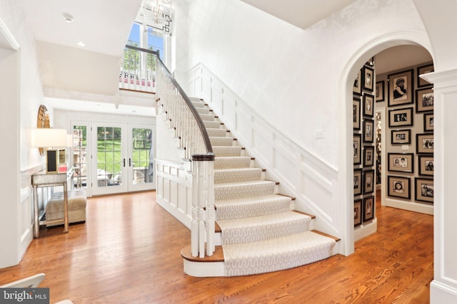 51 Farrier Ln, Newtown Square, PA 19073 - stairway featuring french doors, arched walkways, a high ceiling, and wood finished floors
