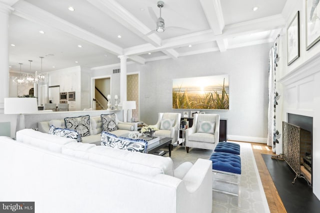 51 Farrier Ln, Newtown Square, PA 19073 - living area featuring decorative columns, beamed ceiling, recessed lighting, wood finished floors, and a fireplace with flush hearth