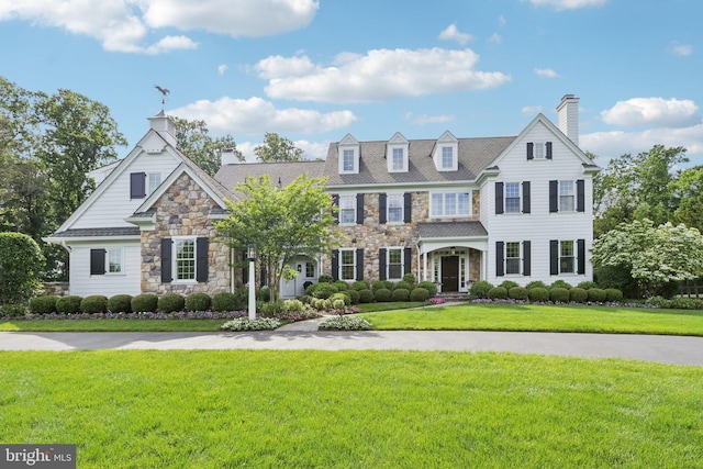 51 Farrier Ln, Newtown Square, PA 19073 - view of front of home with stone siding, a chimney, and a front lawn