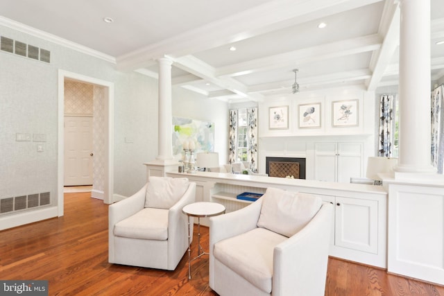 51 Farrier Ln, Newtown Square, PA 19073 - living area with decorative columns, a ceiling fan, wood finished floors, beam ceiling, and a fireplace