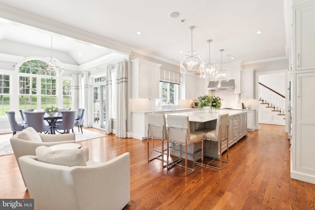 51 Farrier Ln, Newtown Square, PA 19073 - kitchen with a chandelier, under cabinet range hood, a center island, a kitchen bar, and wood finished floors