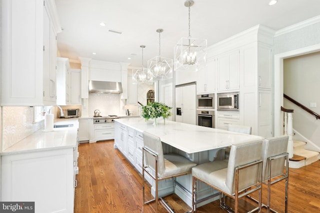 51 Farrier Ln, Newtown Square, PA 19073 - kitchen featuring a sink, extractor fan, white cabinets, built in appliances, and ornamental molding