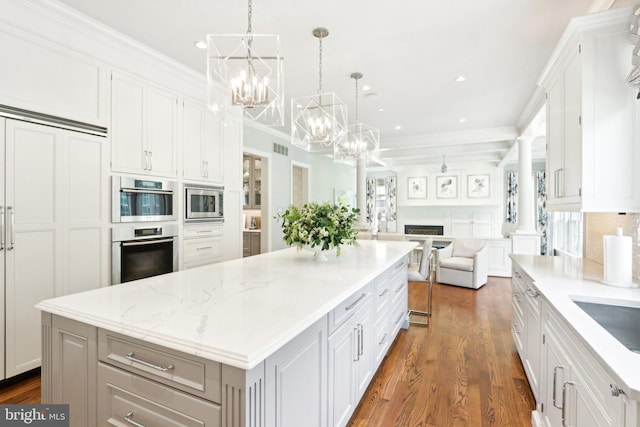 51 Farrier Ln, Newtown Square, PA 19073 - kitchen featuring a chandelier, a kitchen island, white cabinetry, open floor plan, and crown molding