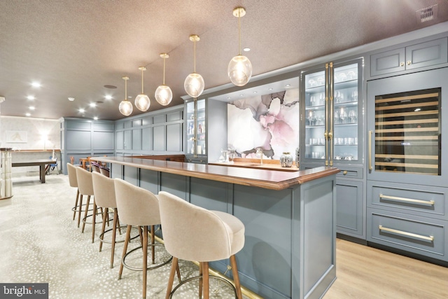 51 Farrier Ln, Newtown Square, PA 19073 - indoor dry bar featuring a textured ceiling, beverage cooler, hanging light fixtures, recessed lighting, and light wood finished floors