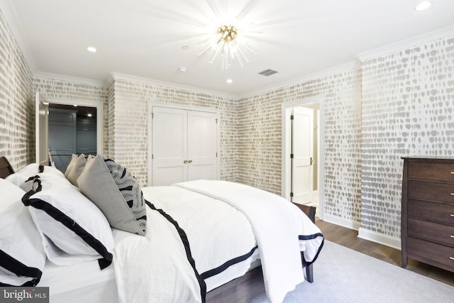 51 Farrier Ln, Newtown Square, PA 19073 - bedroom featuring wood finished floors, a chandelier, ornamental molding, wallpapered walls, and a closet