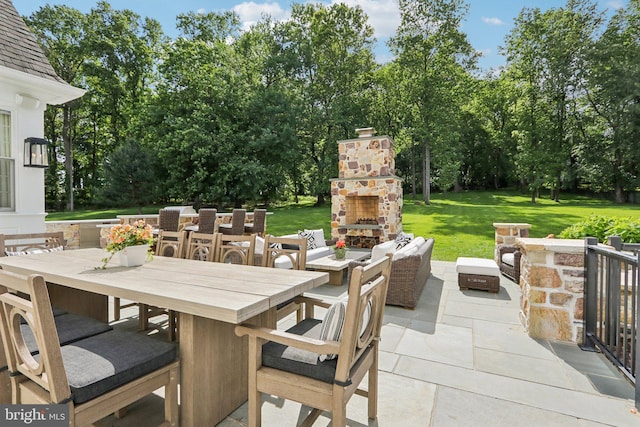 51 Farrier Ln, Newtown Square, PA 19073 - view of patio featuring an outdoor stone fireplace, outdoor dining area, and view of wooded area