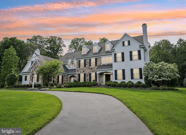 51 Farrier Ln, Newtown Square, PA 19073 - view of front of home featuring stone siding, a lawn, a chimney, and curved driveway