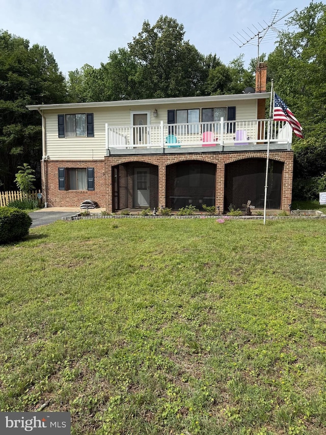388 Monument Dr, Montross, VA 22520 - back of house with brick siding, a chimney, and a yard