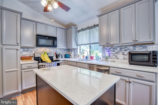 388 Monument Dr, Montross, VA 22520 - kitchen featuring appliances with stainless steel finishes, gray cabinets, lofted ceiling, decorative backsplash, and ceiling fan