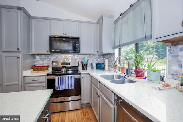 388 Monument Dr, Montross, VA 22520 - kitchen featuring stainless steel range with electric cooktop, black microwave, a sink, gray cabinetry, and decorative backsplash