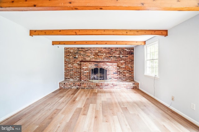 12303 Captain Smith Ct, Rockville, MD 20854 - unfurnished living room with wood finished floors, beamed ceiling, a brick fireplace, and baseboards