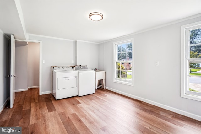 12303 Captain Smith Ct, Rockville, MD 20854 - laundry area with washing machine and dryer, light wood-style floors, baseboards, and crown molding