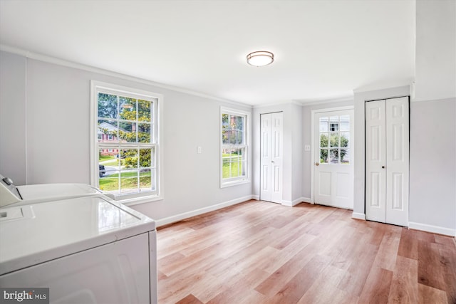 12303 Captain Smith Ct, Rockville, MD 20854 - laundry room with washing machine and clothes dryer, light wood finished floors, ornamental molding, and baseboards