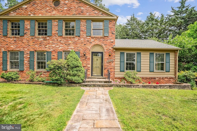 12303 Captain Smith Ct, Rockville, MD 20854 - colonial home with brick siding, a front yard, and a shingled roof