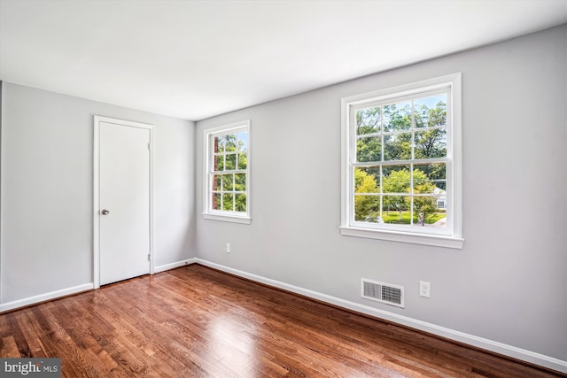 12303 Captain Smith Ct, Rockville, MD 20854 - unfurnished bedroom featuring wood finished floors, multiple windows, and baseboards