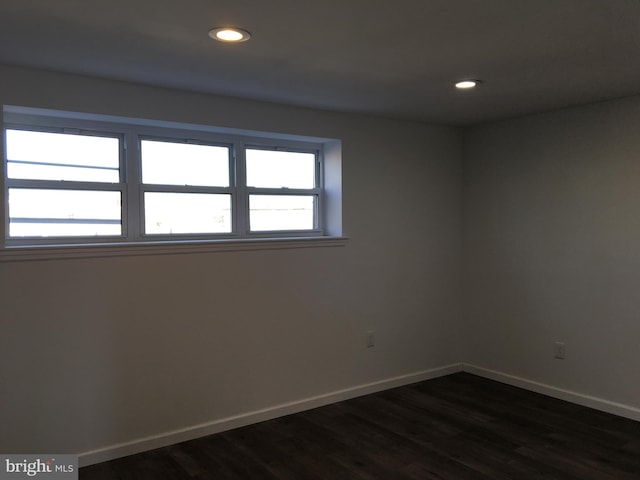 unfurnished room with baseboards, dark wood-style flooring, and recessed lighting
