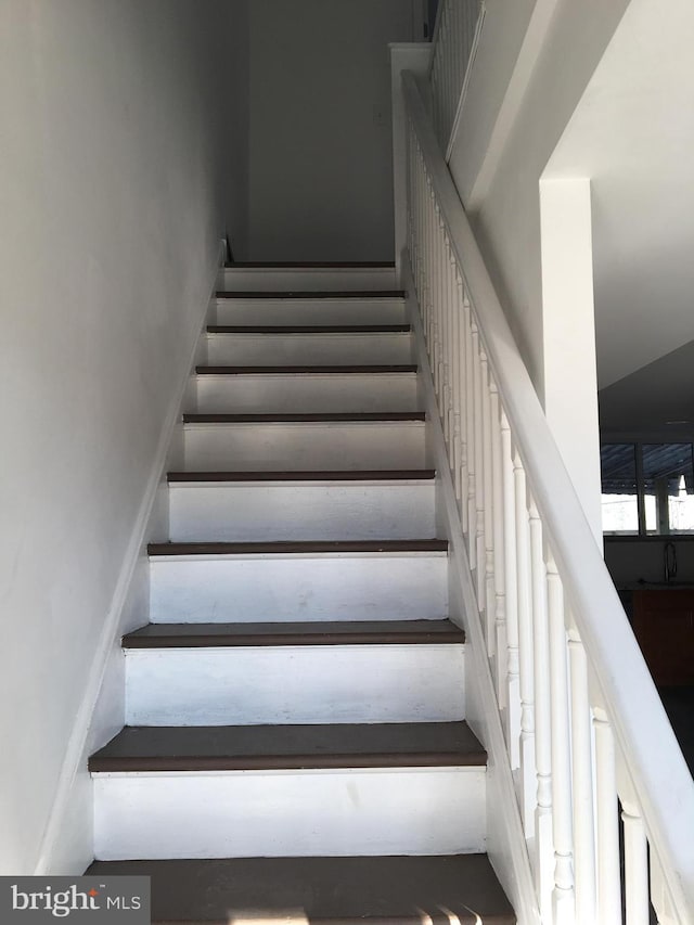stairs featuring a towering ceiling