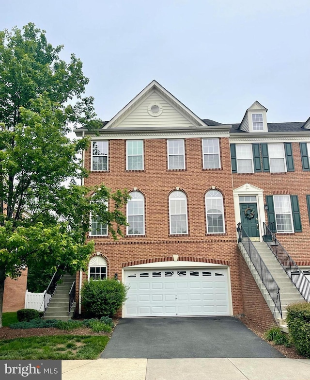 20044 Northville Hills Ter, Ashburn, VA 20147 - townhome / multi-family property featuring stairway, asphalt driveway, a garage, and brick siding