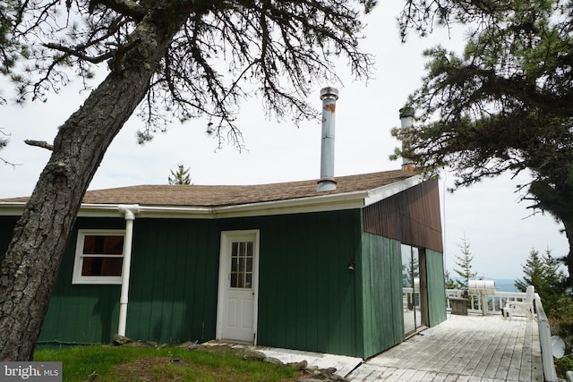 rear view of property with a wooden deck