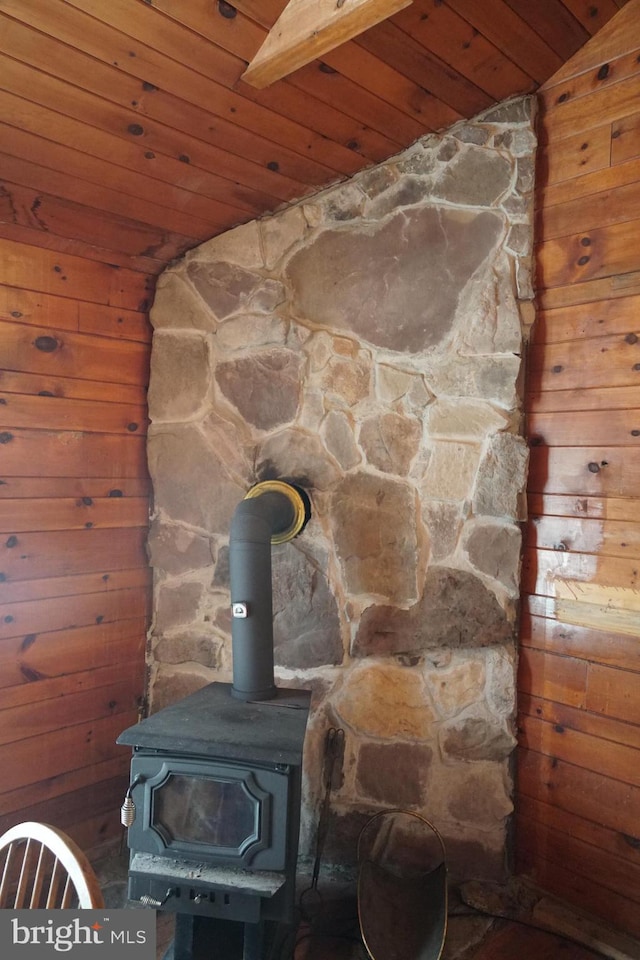 detailed view of wood ceiling, a wood stove, and wooden walls