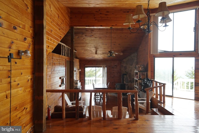 dining room featuring wooden ceiling, high vaulted ceiling, wood-type flooring, and a chandelier