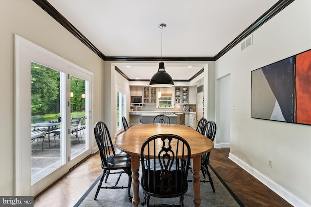 dining room featuring ornamental molding and baseboards