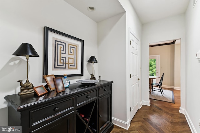 corridor with baseboards and an office area