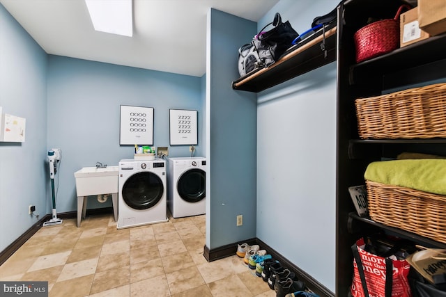 laundry area featuring washing machine and dryer and baseboards