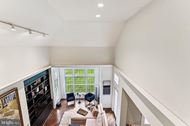 living area with track lighting, vaulted ceiling, wood finished floors, and recessed lighting
