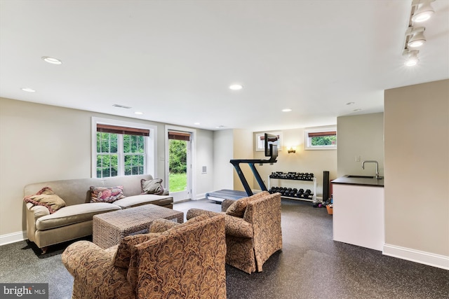 living room with plenty of natural light, baseboards, and recessed lighting