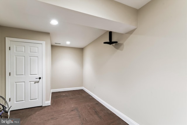 below grade area featuring baseboards and recessed lighting