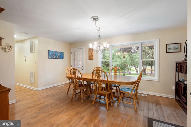328 W Bay Front Rd, Lothian, MD 20711 - dining room featuring a chandelier, light wood-style flooring, and baseboards