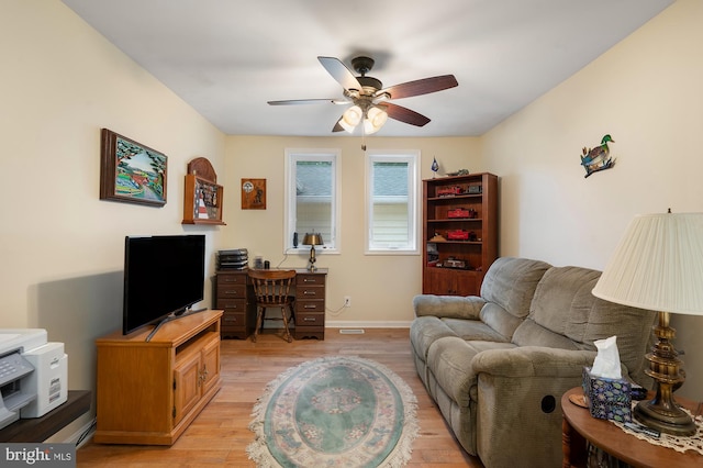 328 W Bay Front Rd, Lothian, MD 20711 - living room with light wood-style floors, a ceiling fan, and baseboards