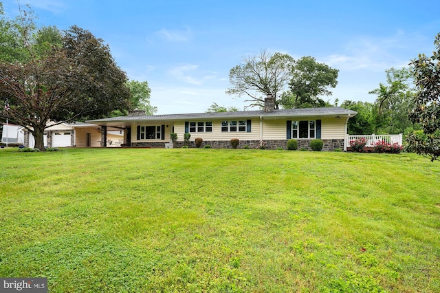 328 W Bay Front Rd, Lothian, MD 20711 - ranch-style house featuring a chimney, a front lawn, stone siding, and a garage