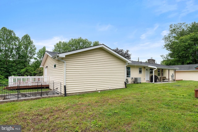 328 W Bay Front Rd, Lothian, MD 20711 - back of property with a patio area, a lawn, cooling unit, a chimney, and a deck