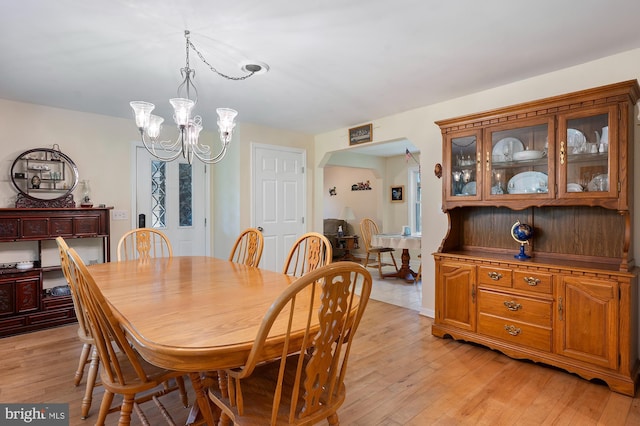 328 W Bay Front Rd, Lothian, MD 20711 - dining space featuring arched walkways, a chandelier, and light wood-style floors