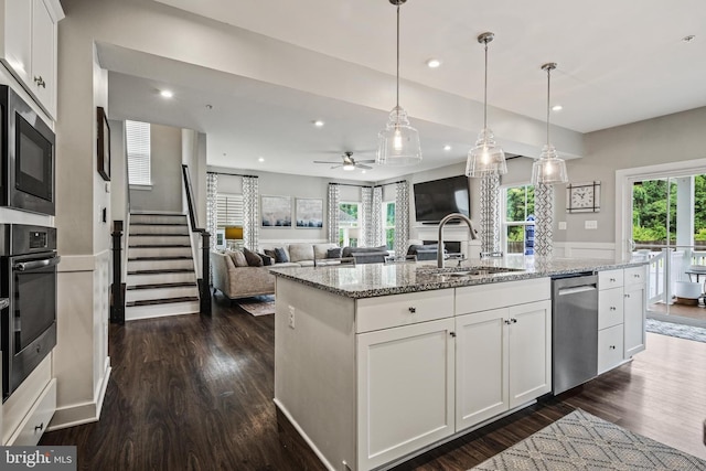 kitchen featuring a sink, appliances with stainless steel finishes, dark wood-type flooring, white cabinetry, and recessed lighting
