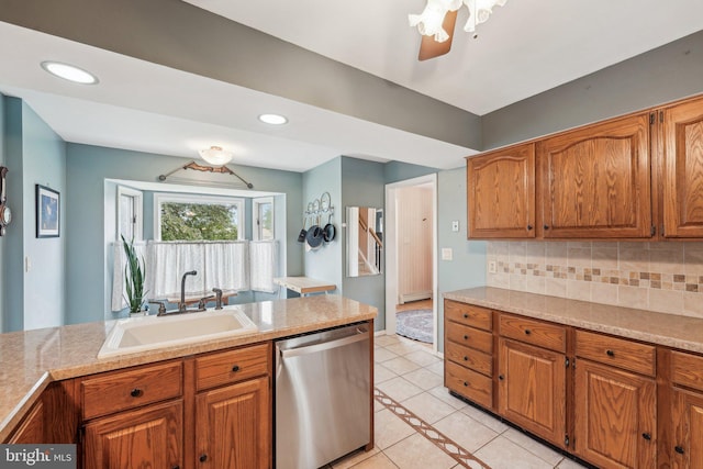 kitchen with dishwasher, a sink, light tile patterned floors, brown cabinets, and recessed lighting