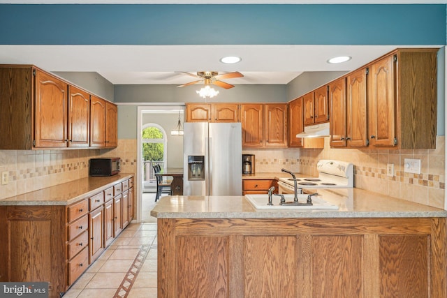 kitchen with stainless steel fridge with ice dispenser, under cabinet range hood, black microwave, a peninsula, and white electric range oven