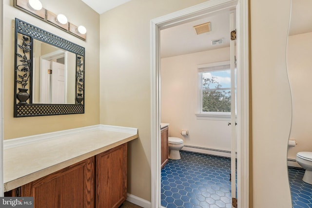 bathroom with toilet, baseboard heating, and vanity