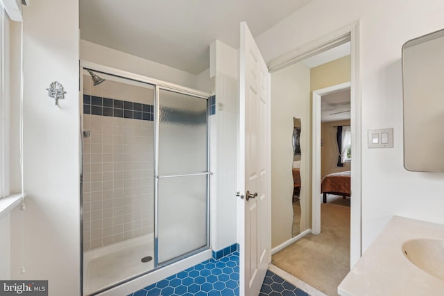 ensuite bathroom with a stall shower and a sink