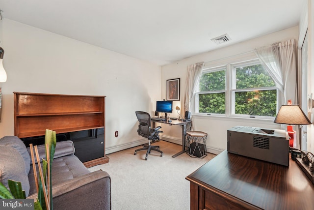 carpeted office space with baseboard heating
