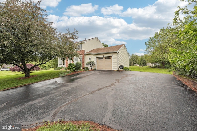 view of property exterior featuring a garage, driveway, and a lawn